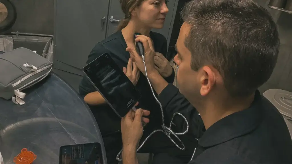 Polaris Dawn crew members practice using a handheld Butterfly iQ+ device for ultrasound imaging. The Polaris Dawn mission is slated to launch in 2023.Â Â 